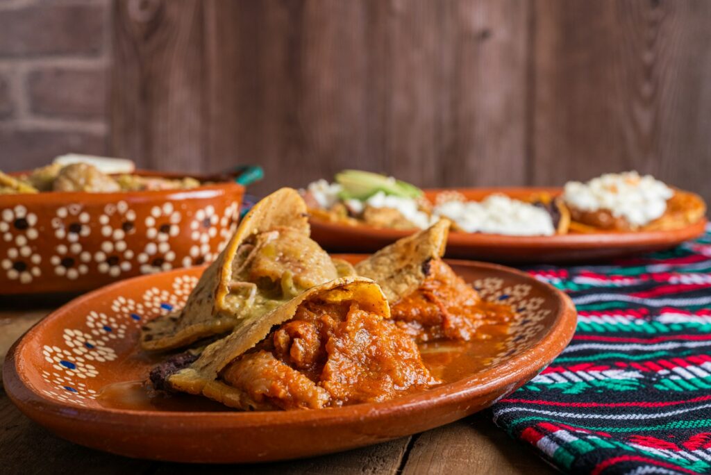 Gorditas de chicharron in green sauce and red sauce. Mexican food.