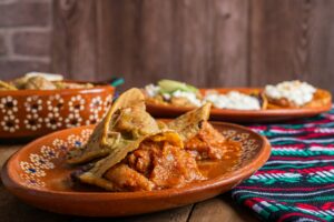 Gorditas de chicharron in green sauce and red sauce. Mexican food.