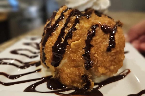 Dessert: "A beautifully presented dessert of churros served with a side of rich chocolate sauce."