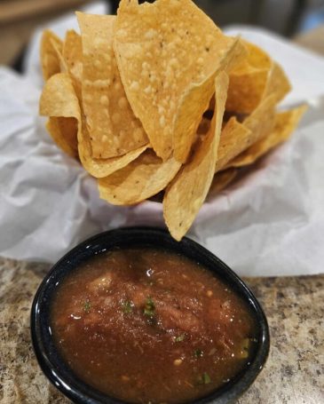 Fresh Salsa: "Bowl of freshly made salsa with diced tomatoes, onions, cilantro, and jalapeños, ready to be served."